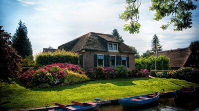 Home with manicured lawn and lush garden